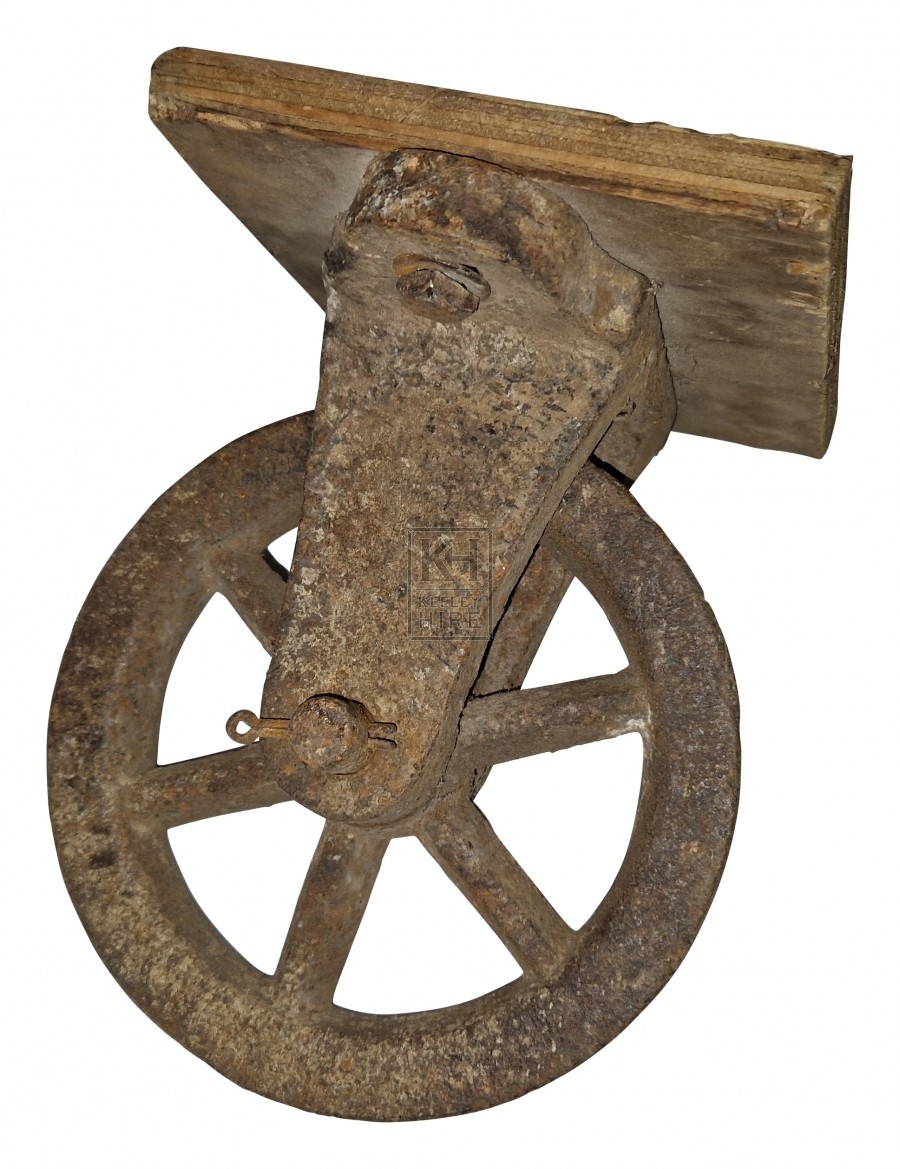 Small iron pulley on wood plate