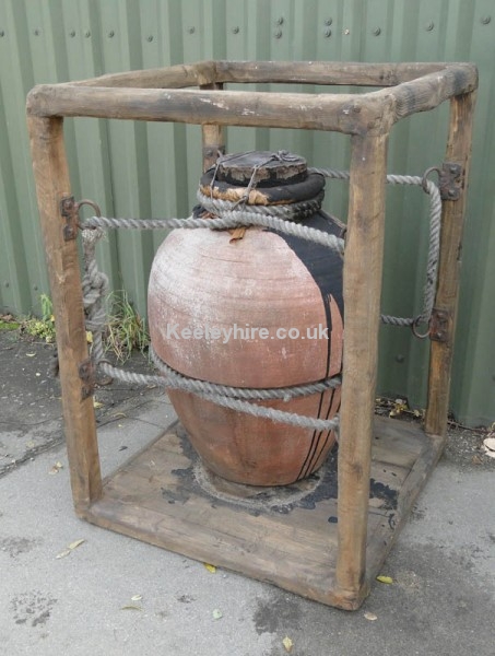 Very large earthenware urn in wood frame
