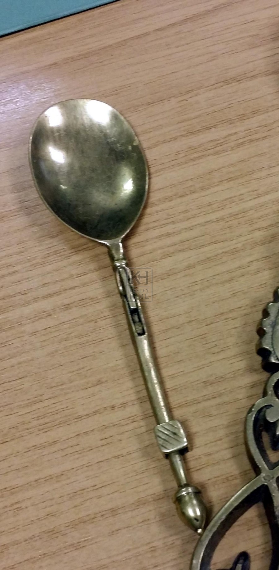 Folding brass spoon