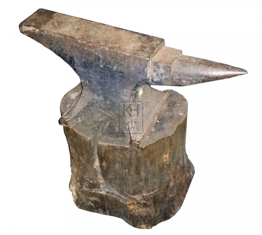 Iron anvil on wood stump