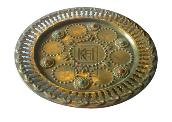 Small brass plate with stones
