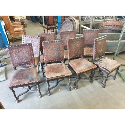 Worn embossed & studded leather chairs